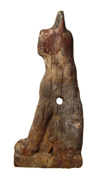 Egyptian carved wooden relief of a seated cat: A carved wooden relief of a seated cat, 3rd Intermediate - Late Period, c. 1075 - 343 BC, representing the goddess Bastet. Nicely carved with some minor losses, age cracks and deposits. The back is fl