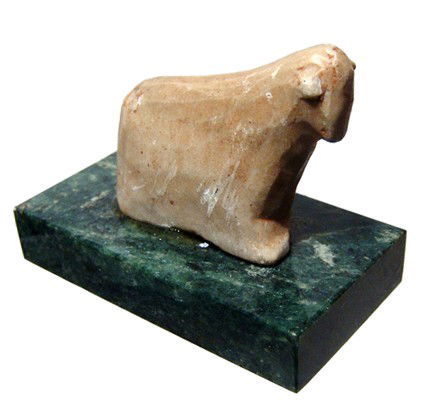 Near East, alabaster figure of a bull: An alabaster figure of a bull, Near East, 2nd Millennium BC, rather stylized, the horns indicated at the sides of the head. Intact with traces of an orange pigment. H: 33mm; H: 37mm. Mounted on a ston