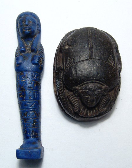 Pair of antique Egyptian items: A pair of antique Egyptian items. The lot includes a large black-slipped terracotta scarab, Ramesside style, L: 3 1/4" (8.3 cm), and a blue glass ushabti, L: 5" (12.7 cm). Both intact, the scarab with