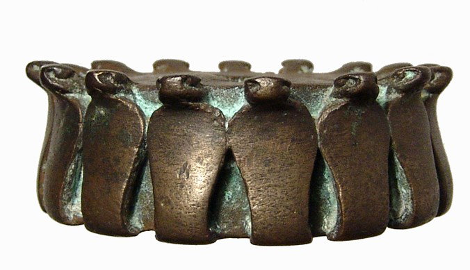 Egypt. Bronze headdress element with cobras: A bronze headdress element with erect cobras, Saite, Dynasty 26, c. 664 - 525 BC, the uraei side-by-side. The piece is circular with a rectangle cut at the center to fit the other parts of the headdre