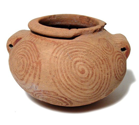 Pre-Dynastic spiral decorated jar, Naqada II: A pleasing Pre-Dynastic spiral decorated squat jar, Naqada IIb - IId2, c. 3700 - 3300 BC, with flattened rim and wide lug handles. The surface is decorated with spirals in red slip, contrasting nicely