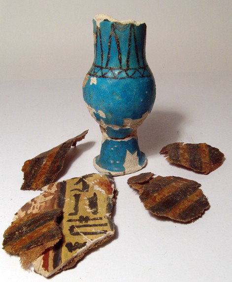 Fragmentary faience jar & painted cartonnage: A fragmentary faience jar and painted cartonnage. Lot includes a Middle Kingdom faience vessel, fragmentary and in two part, nicely decorated around the sides in black. H: 4 5/8" (11.8 cm); and also f