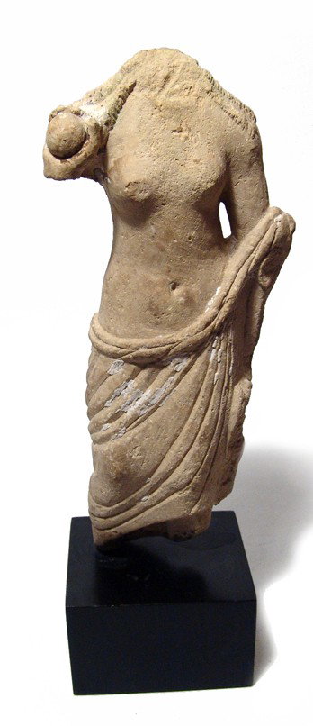 Roman limestone torso of Aphrodite: A Near Eastern Roman limestone torso of Aphrodite, 3rd Century AD, drapery around hips and left arm, right hand holding an apple, her hair in tight ringlets falling to an even length along her shoulde
