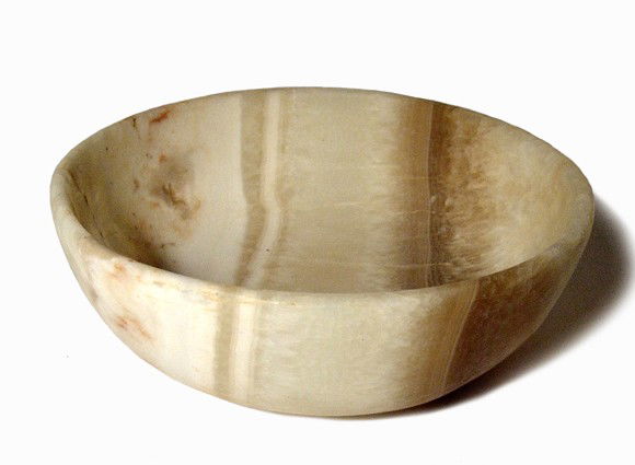 Ancient Egyptian-style alabaster bowl: An ancient Egyptian-style alabaster bowl, nicely formed with a raised disk foot. Intact with nice translucent walls with beautiful banding. H: 2" (5.1 cm); Dia: 5 1/8"(13 cm). Ex Donald Simmounds coll