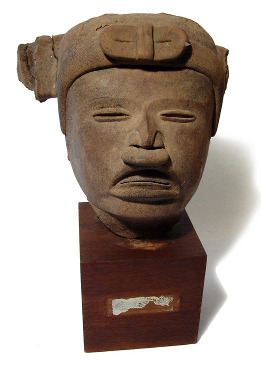 Large Vera Cruz terracotta head from Mexico: A large and attractive Vera Cruz terracotta head, Mexico, c. AD 300 - 900, with handsome features, the eyes narrowed and mouth opened to reveal the teeth. The figure wears a nose plug and a head dress