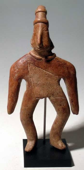 Fine Colima figure from West Mexico: A fine Colima figure from West Mexico, c. 300 BC - AD 300, a large archaic example depicting an individual wearing a mantle that is created by incising and surface texture, front and back. He is adorn
