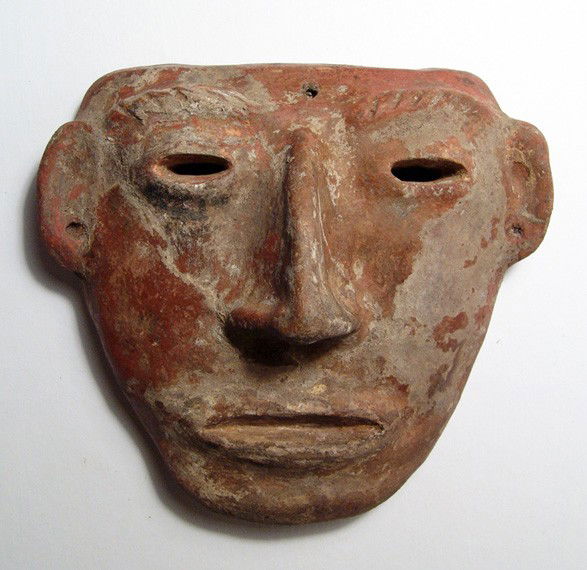 Nice Calima human faced mask, Colombia: A nice Calima human faced mask, Colombia, c. 500 - 300 BC, the large nose and small eyes, the lips purses and the brows heavy. 6" x 6 1/2" (15.2 x 16.6 cm). Intact, age crack at top of head, earthen d