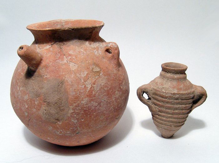 Early Bronze Age spouted jar & Roman amphora: An Early Bronze Age spouted jar and a Roman ribbed amphora. The jar is round-bodied with lightly indented base, the rim folded out and flanked by two pinched handle, a small circular spout on one side
