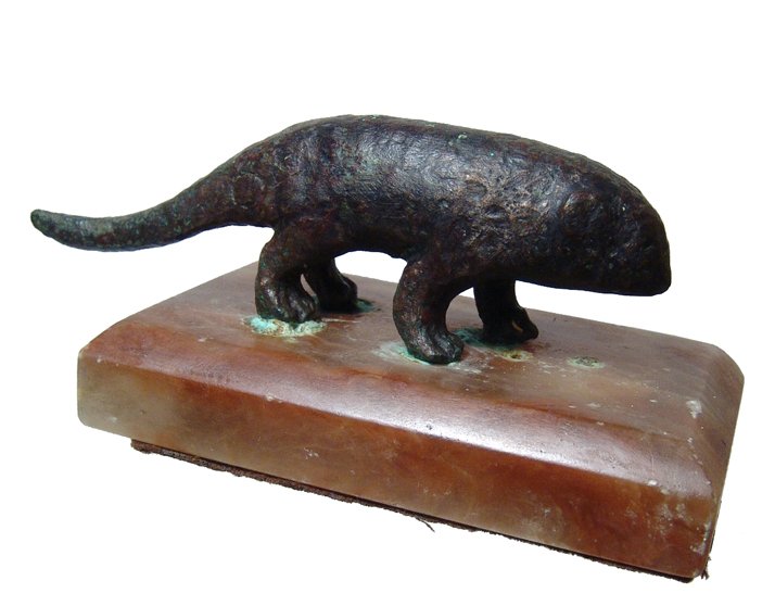 Egyptian bronze figure of a shrew, Late Period: An Egyptian bronze figure of a shrew, Late Period, c. 664 - 343 BC, left legs forward and tail straight behind. L: 4" (10.1 cm). Intact with brown patination. Mounted to an antique marble base. Ex Eng
