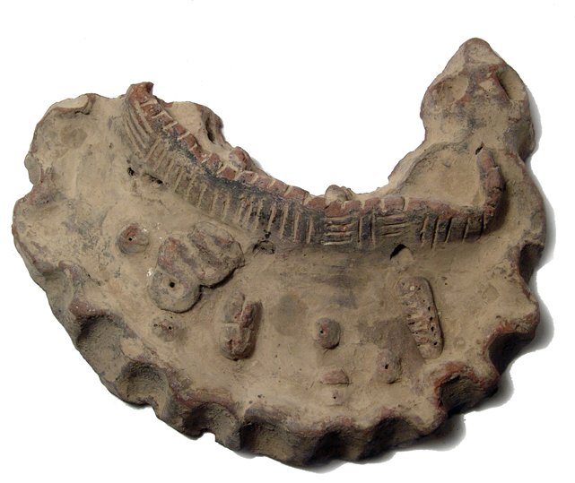 Egyptian terracotta offering tray, New Kingdom: An Egyptian terracotta offering tray, Late New Kingdom, c. 1292 - 1075 BC, hand modeled and roughly crescent or collar-shaped, with a wall or lower structure detailed with incised lines bordering the 