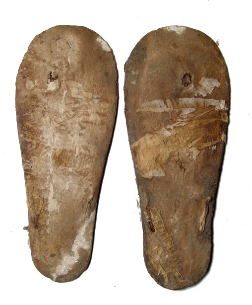 Amazing pair of Coptic sandals, Egypt: A pair of Coptic sandals, c. 3rd - 5th Century AD, the wooden bottom of each still largely intact, some of the fabric of the straps and the upper portion still remaining. One the base of one is the re