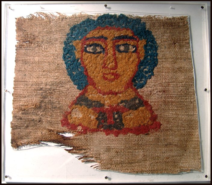 Fine Egyptian Coptic textile with bust of a lady: An Egyptian Coptic textile with bust of a lady, Roman Period, c. 5th century AD, wool and linen, with bright orange, red, blue and brown colors. 10" x 8 1/2" (25.4 x 21.6 cm). Nicely mounted in a cust