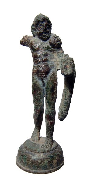 Roman bronze figure of Hercules: A Roman bronze figure of Hercules, c. 2nd - 3rd Century AD. The god stands upon a domed base with lion's skin draped over his shoulders and left arm. The right arm, which presumably held a club, is no
