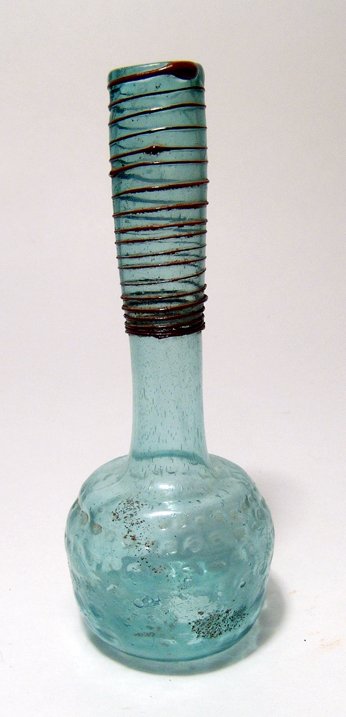 Late Roman / Byzantine tall-necked bottle: A Late Roman / Byzantine tall-necked bottle, c. 5th - 6th Century, of pale blue glass, the body decorated with rows of dimples, the base lightly indented. The neck is quite tall and tubular with verti