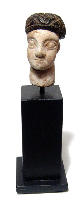 Bactria-Margiana stone head from a large figure: A limestone head from a large composite stone figure, Bactria-Margiana, late 3rd - early 2nd Millennium BC, wearing chlorite or steatite cap with nicely incised detail. The head is finely modeled with