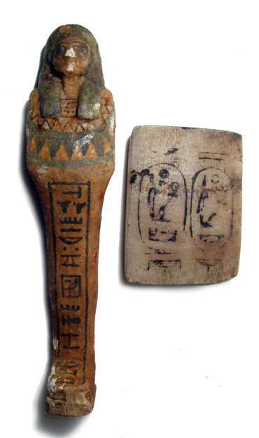 Painted wooden ushabti and alabaster relief: A painted wooden ushabti and an alabaster relief with two cartouches, early 20th Century, the cartouches representing the pharaohs Amenhotep III and Merenptah. The wooden ushabti of New Kingdom style