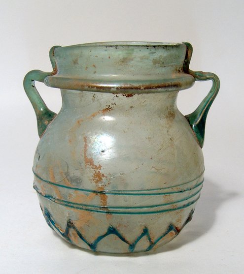 Roman blue glass jar, zigzag trail decoration: A Roman pale blue glass jar with zigzag trail decoration, Eastern Mediterranean, c. 4th Century AD, the body spherical with indented base and pontil mark. The body is decorated with a band of zigzag t
