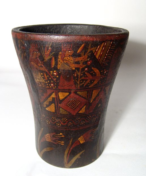 Inca colonial painted wooden kero, Peru: Pre-Columbian. An Inca colonial painted wooden kero, Peru, c. AD 1600 - 1700, with ceremonial scene above rectangular bands of geometric devices, stylized plants below. Intact with some minor retouchi