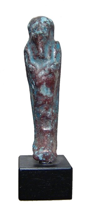 Blue-purple faience ushabti, Ex Royal Athena: An Egyptian faience ushabti with nice blue-purple color, Ptolemaic, c. 305 - 30 BC, mummiform, wearing tripartite headdress and false beard, arms crossed over chest, hands holding a pick and hoe. Inta