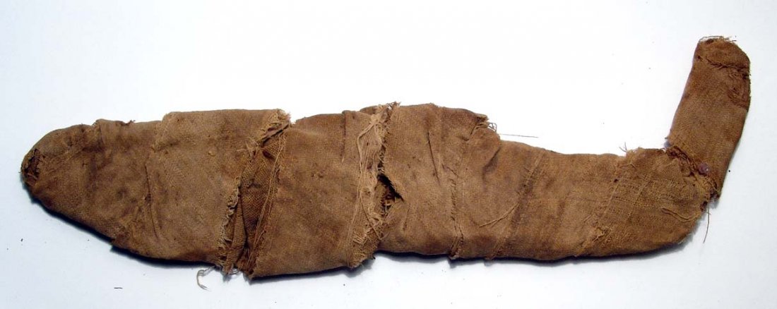 Graeco-Roman mummified fish, Egypt: A Graeco-Roman mummified fish, c. 3rd - 1st Century BC. Tightly wrapped in linen bandages, the outer covering having been removed, otherwise intact and interesting. L: 10 1/2" (26.5 cm).