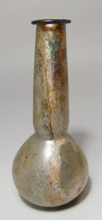 Roman glass bottle with exceptional iridescence: An attractive Roman glass bottle with exceptional iridescence, c. 2nd Century AD, of a pale yellow glass, the body pear shaped with flattened base, the neck tubular with constriction just above the sh