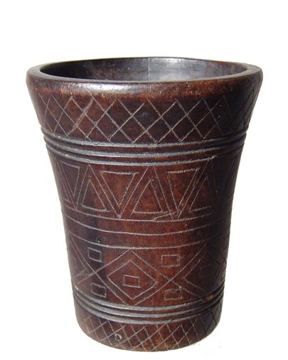 Inca Colonial incised wood kero, Peru: An Inca Colonial incised wood kero, Peru, c. AD 1532 - 1700, nicely decorated with band of geometric devices, each precisely cut into the sides. H: 3 1/4" (8.2 cm). A few minor age cracks, nicely poli