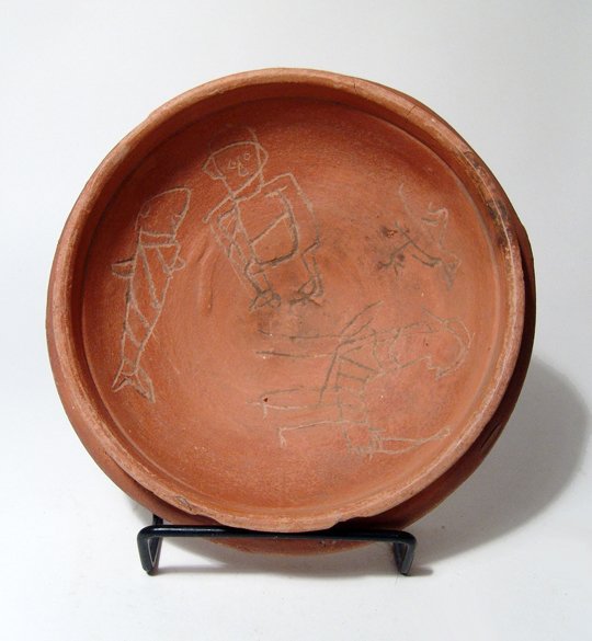 Ex Royal Athena Galleries, New York.: A Coptic red-ware pottery magic bowl, Egypt, c. 5th - 6th Century AD, with images incised in the vessel's interior. The incised figures include a standing helmeted figure, another standing figure hold