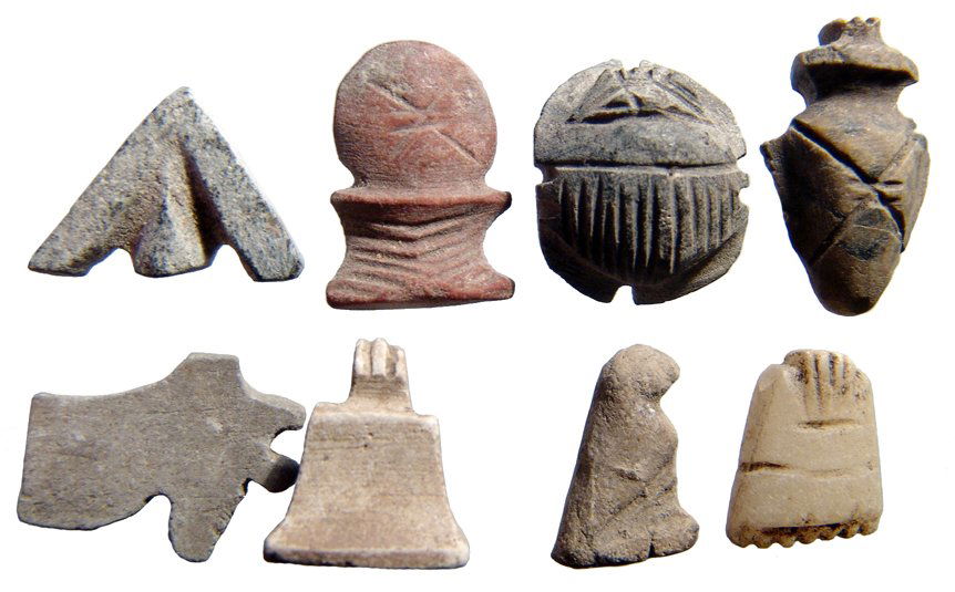 Group of 8 Egyptian stone amulets: A group of 8 Egyptian stone amulets, Late Period, c. 712 - 343 BC, including a 'Wedjat', or Eye of Horus, 21x16mm; a nicely detailed scarab with flat base, 20x16mm; a solar disk, 22x14mm; an 'Ib' or h
