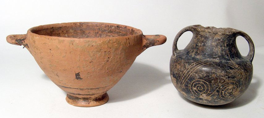 Proto-Corinthian Skyphos & Etruscan Amphora: A Proto-Corinthian Skyphos and an Etruscan Bucchero Amphora. The first vessel, a Proto-Corinthian Skyphos, c. 700 - 675 BC, with dark banding. H: 3 3/8" (8.6 cm); W: 7 1/4" (18.4 cm). Surface weatheri