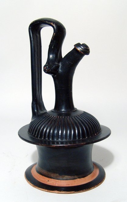 Choice Apulian Gnathian-Ware Epichysis: A choice Apulian Gnathian-Ware Epichysis, Magnia Graecia, c. 330 - 300 BC, of spindle body form, the shoulder with ribbing and lion heads at the juncture of the arching handle and the pinched spout. H
