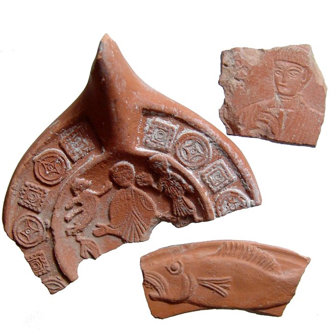 Roman North Africa red-ware pottery & lamp sherds: A lot of 3 Roman red-ware pottery and lamps sherds, North Africa, 4th - 5th Century AD, including a lamp fragment with some kind of Christian scene, a bowl rim fragment featuring a nicely modeled fish