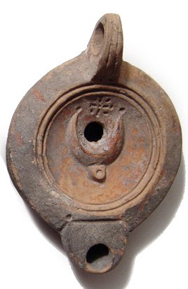 Roman red-ware ceramic lamp, crescent of Diana: A Roman red-ware ceramic lamp with crescent of Diana, c. AD 90 - 140, the side sharply carinated, the discus set off from the shoulder by a ridge and two grooves, the spout is short with rounded nozzl