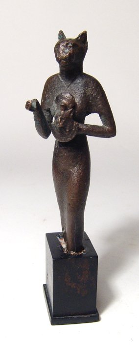 Egyptian bronze figure of the goddess Bastet: An Egyptian bronze figure of the goddess Bastet, Late Period, 26th Dynasty, c. 664 - 525 BC, wearing a long, tight-fitting gown, right hand held out before her, hand grasping a staff which is no longe