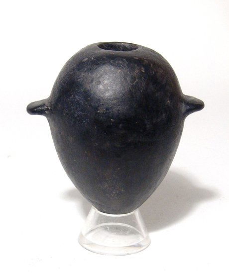 Predynastic black-ware cosmetic jar, Naqada II: A nice Predynastic black-ware cosmetic jar, Naqada II, c. 3650 - 3300 BC, perfectly crafted to fit comfortably in the hand. The body ovoid with two ledge handles and a near pointed base, the shoulders