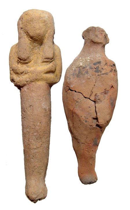 2 terracotta ushabtis, Late New Kingdom Egypt: A pair of Egyptian terracotta ushabtis, Late New Kingdom, c. 1292 - 1075 BC, the of a more characteristic form, the body mummiform and wearing tripartite headdress, arms folded across chest, hands hol