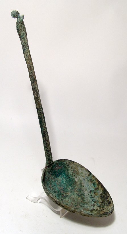 Central Asian bronze ladle, c. 1000 - 600 BC: A large Central Asian bronze ladle, c. 1000 - 600 BC, with deep oval bowl, the handle long and flat with braided decoration, the end decorated with two rows of coiled wire, and surmounted by a curled 