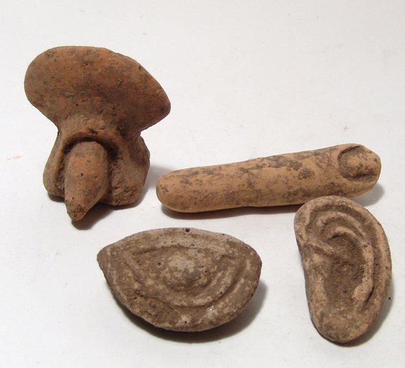 Group of 4 Etruscan terracotta votive objects: A group of 4 Etruscan terracotta votive objects, c. 5th - 4th Century BC. Lot includes a long finger with detailed nail, L: 3 1/2" (8.9 cm), the male sexual organ, 2 1/2" x 2" (6.4 x 5.1 cm); a human 