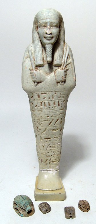 Grand Tour. Egyptian ushabti and 4 scarabs: An Egyptian ushabti and 4 scarabs. Lot includes an attractive ancient-style Egyptian ushabti, mid-20th Century, in handsome style, L: 7 5/8" (19.4 cm), and four carved scarabs, also in ancient style, 