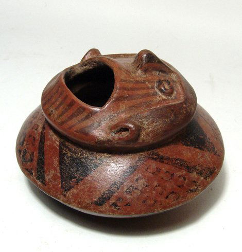 A Narino seated figural jar (Griton) from Columbia: A Narino seated figural jar (Griton), Columbia, AD 850 - 1500, featuring a man with an open mouth. The vessel is nicely decorated with red slip with black resist. H: 3 ½” (8.9 cm); Dia: 5 ½” (13
