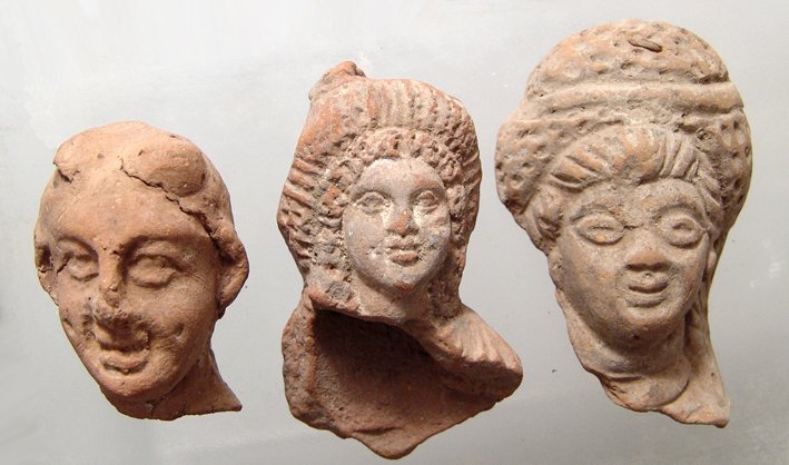 A lot of 3 Egyptian terracotta heads, Ptolemaic: A lot of 3 Egyptian terracotta heads, Ptolemaic, c. 3rd - 1st Century BC, the first a well-detailed head of a lady with large rolled diadem, the second a lady with large eyes and a large diadem, and a