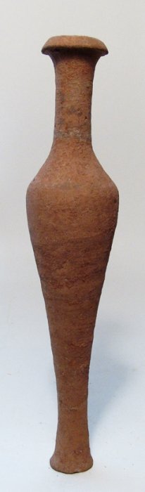A Roman spindle bottle: A Roman spindle bottle, c. 1st - 2nd Century AD, the body tapering to a wide, flat foot, the neck tubular with well-formed rim. H: 23.3 cm). Intact and a very nice example! Ex Philadelphia private col