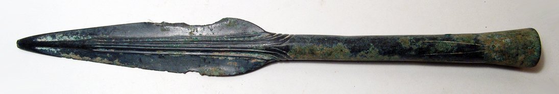 An attractive bronze spear head, Northern Iran: An attractive bronze spear head, Northern Iran, c. 1200 - 1000 BC, with long body and short leaf-shaped blade, the midrib decorated and accentuated by incised vertical lines, large incised triangles a