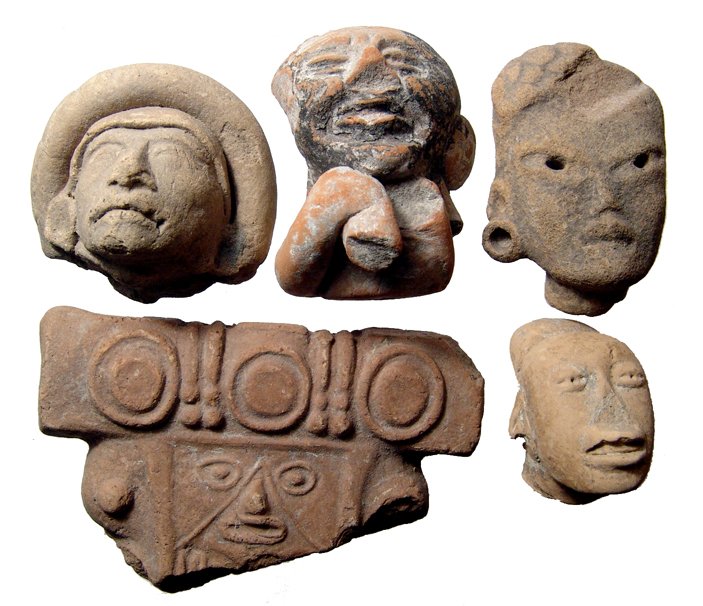 A group of 7 Pre-Columbian terracotta heads & rollers: A group of 7 Pre-Columbian terracotta heads & rollers. Four of the heads are Huastec, c. AD 200 - 500, and the one with the large headdress is from Teotihuacan, c. AD 400 - 600. Largest head measures 