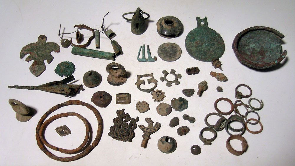 Near Eastern and Roman metal artifacts: A lot of Near Eastern and Roman metal artifacts, including a 3" long incised bronze ornament, a bronze bell, various finials, rings, tube beads, buckles and other assorted objects. Ex Khan collection.
