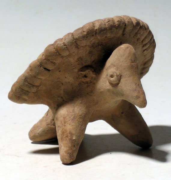 Colima bird whistle from West Mexico: A fine Colima bird whistle from West Mexico, c. 300 BC - 300 AD. It is 3" long and depicts an Oscillated Turkey, with its tail feathers spread into a fan. Strong mineral deposits, good tone on the whi