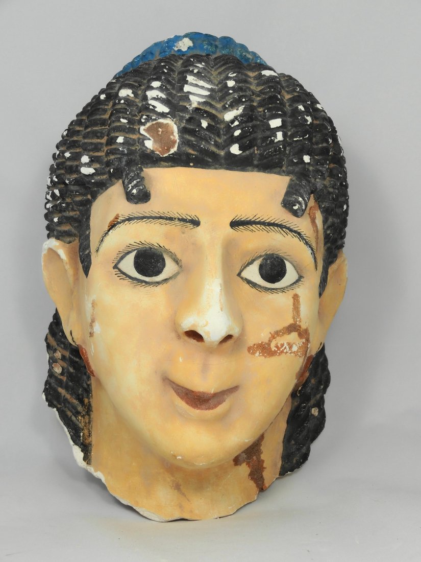 Beautiful complete Hellenistic/Egyptian mummy mask: A beautiful complete Hellenistic/Egyptian mummy mask depicting an aristocratic woman at the height of her beauty, H: 10 1/4" (26cm), W: 6 3/4" (17cm). Her hair, most likely a highly detailed black wig