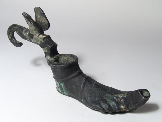 Grand Tour Roman-style bronze lamp: A nice Grand Tour Roman-style bronze lamp in the form of a sandal, late 19th Century, nicely modeled with what appears to be either a winged phallus or stylized bird on the back of the fill-hole. L: 6