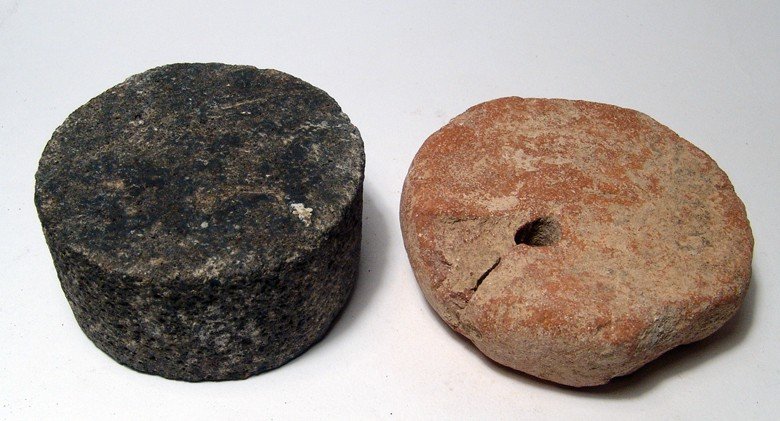 A Chalcolithic loom weight from Byblos: A Chalcolithic loom weight from Byblos, c. 5th Millennium BC, of circular shape with hole for suspension, Dia: 3 3/4" (9.5 cm), with old collection label. Also included a circular stone weight, Near E
