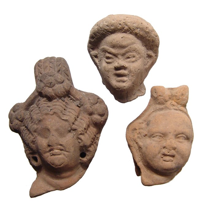 Lot of Egyptian terracotta heads, Graeco-Roman: Lot of Egyptian terracotta heads, Graeco-Roman, c. 2nd Century BC/AD, each nicely detailed, one a woman with elaborately styled coiffure and ears pierced for earrings, H: 3” (7.6 cm), a head of a ma