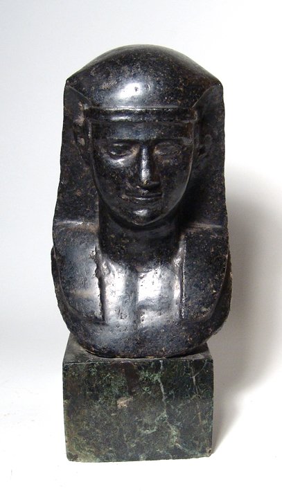 Roman Egyptianized basalt Bust of Antinous: A Roman Egyptianized basalt Bust of Antinous, the favorite of Hadrian, Mid-2nd Century AD, his features sensitively rendered and he wears a Nemes head cloth with lappets, his chest bare. H: 5 3/8" (13